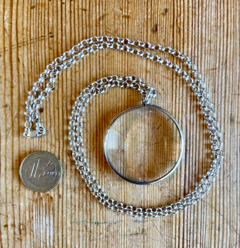 Silver magnifying glass on chain